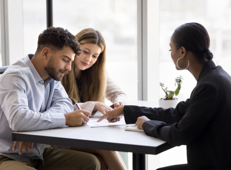 Young couple signs FHA mortgage loan